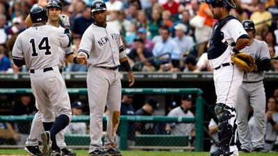 Curtis Granderson, wearing the 14 shirt, is congratulated by New York Yankees teammates after his three-run homer