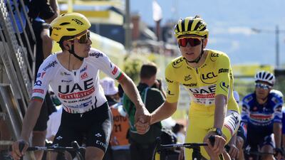 Yellow jersey Slovenian rider Tadej Pogacar (R) of UAE Team Emirates shakes hands with teammate Portuguese rider Joao Almeida after crossing the finish line of the 18th stage of the 2024 Tour de France cycling race over 179km from Gap to Barcelonnette, France, 18 July 2024. EPA / GUILLAUME HORCAJUELO