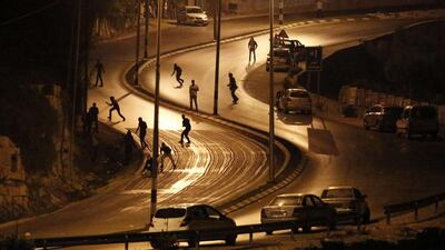 Palestinians clash with Israeli security forces in the town of Surda, the hometown of Palestinian Mohannad Shafiq Halani, who carried out an attack in which two Israelis were killed and two others wounded in the Old City of Jerusalem, as Israeli forces search and surround his house, near the West Bank city of Ramallah. Halani was shot dead by police after the attack. Abbas Momani / AFP