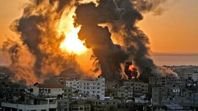 A fire rages at sunrise in the city of Khan Yunis, following an Israeli air strike on targets in the Gaza Strip. AFP