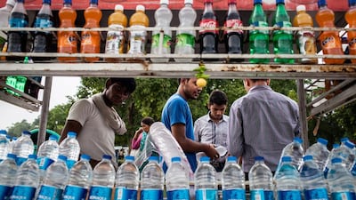 Members of the Indian Hotel and Restaurant Association have decided to take Coca-COla andPepsi off their shelves in a silent protest against Israel's bombing of the Gaza Strip. Seen here is a street vendor selling Coca-Cola Co. products on a cart in New Delhi, Indiaa on July 28, 2012. Sanjit Das/Bloomberg