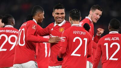 Brazilian midfielder Casemiro (C) celebrates with teammates after scoring their second goal during the English FA Cup fourth round football match between Manchester United and Reading. AFP.