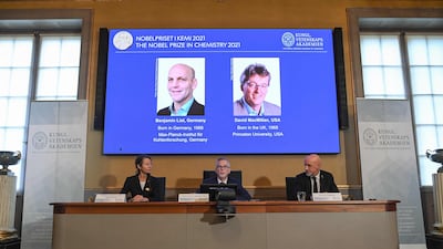 Scientists Benjamin List and David MacMillan are displayed on a screen in Stockholm after winning the Nobel Chemistry Prize. AFP