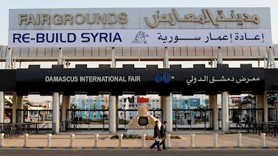 Chinese visitors arrive at the opening of the Syria rebuilding exhibition at the fair ground in Damascus, Syria. AP