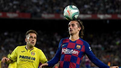 Barcelona's French forward Antoine Griezmann heads the ball next to Villarreal's Spanish midfielder Ruben Pena. AFP