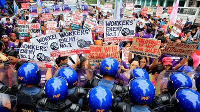 Anti-riot policemen block members of the GABRIELA (Women's Group), who denounced the planned visit of US president Donald Trump's attendance at the 31st Association of Southeast Asian Nations (ASEAN) leaders summit in Manila, Philippines. Romeo Ranoco / Reuters