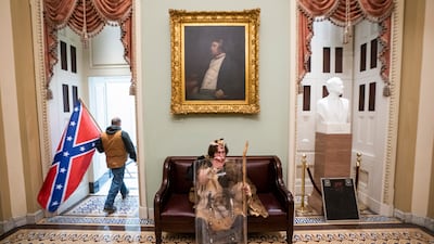 A Confederate flag, considered by many to be a racist hate symbol, is brought into the US Capitol as a mob of pro-Trump loyalists attempt to overturn the results of the 2020 election. EPA