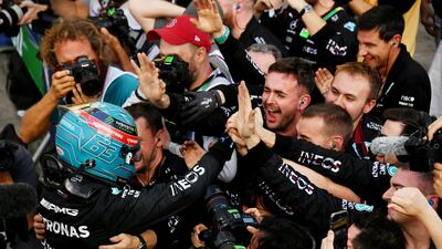 George Russell celebrates with his Mercedes team after finishing in pole position for the Brazilian Grand Prix. Reuters