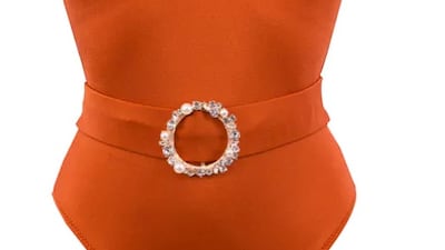 Belted swimsuits: evoking the same shade as a Bora Bora sunset, the orange Dora swimsuit by Lovekini features a rose gold crystal pearl embellished buckle on the belt; Dh606, Lovekini at sanddollardubai.com. Photo: Sand Dollar Dubai