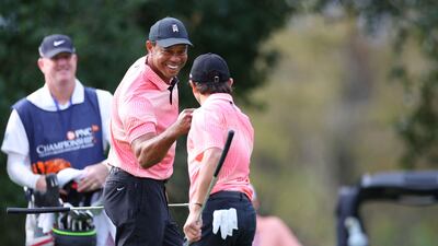 Tiger Woods and Charlie Woods celebrate on the ninth green during the first round of the PNC Championship. Getty