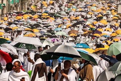 Pilgrims take shelter under umbrellas at the base of Mount Arafat. AFP