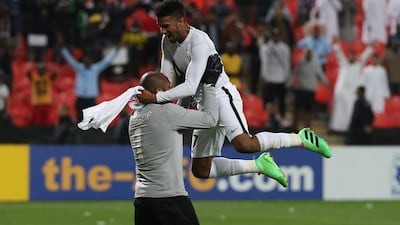 Sultan Al Shamsi of Al Jazira, top, celebrates with goalkeeper Ali Kasheif after Al Jazira advance in the Asian Champions League. Adil Al Naimi / Al Ittihad
