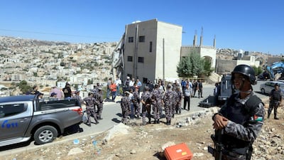 Jordanian security forces gather near a damaged building in the city of Salt, northwest of the capital Amman, on August 12, 2018. AFP