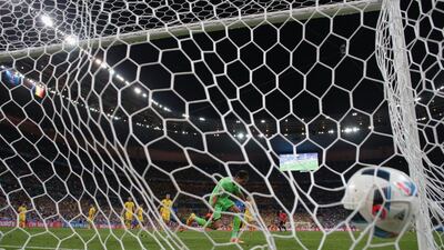 Ciprian Tatarusanu of Romania watches the ball as Dimitri Payet of France scores his team’s second goal during the Uefa Euro 2016 Group A match between France and Romania at Stade de France on June 10, 2016 in Paris, France. (Clive Rose/Getty Images)