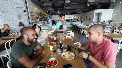 Diners enjoy their meal at the Tom & Serg cafe at Al Joud Center in Al Quoz area in Dubai. Pawan Singh / The National