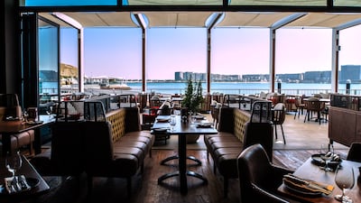 Families can look out over the water while taking advantage of Hunter & Barrel's kids eat free offer. Victor Besa / The National