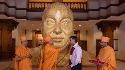 Hindu priests greet British Prime Minister Rishi Sunak at the Swaminarayan Akshardham temple. Photo: BAPS