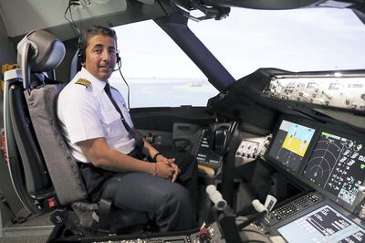 Capt Obaid sits in an Etihad Boeing 787 flight simulator at the carrier's headquarters in Abu Dhabi. Pawan Singh / The National