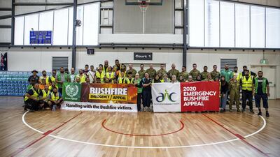 The volunteers pose with firefighters. Courtesy of Australian Islamic Centre