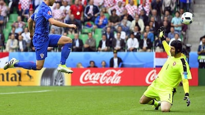 Croatia's Ivan Rakitic, left, scores against Czech Republic in a Group D match that would eventually finish 2-2. Joe Klamar / AFP