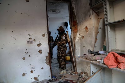 Taliban inspect the scene of an operation against the ISIS militants at a hideout on the outskirts of Kabul. EPA