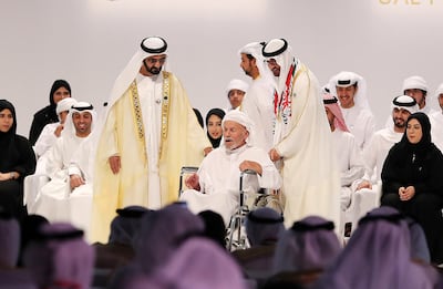 Sheikh Mohammed bin Rashid (left) and Sheikh Mohammed bin Zayed (right) award Saif Al Mansoori from Abu Dhabi with a UAE Pioneers Award for charitable work. Pawan Singh / The National