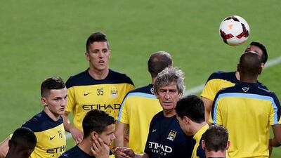 Manchester City manager Manuel Pellegrini, in blue, leads an open training session for fans at the Mohammed bin Zayed Stadium in Abu Dhabi on May 14, 2014. Satish Kumar / The National