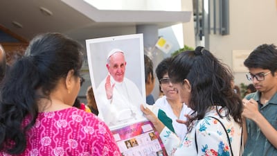 People check out the calendars with Pope Francis image.