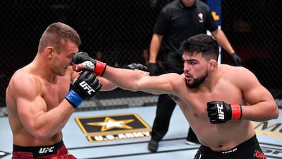 Kelvin Gastelum, right, punches Ian Heinisch in their middleweight fight during the UFC 258 event at UFC APEX in Las Vegas, Nevada. Jeff Bottari / Zuffa LLC / UFC