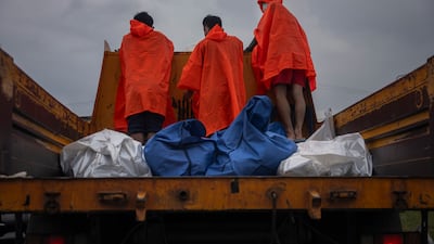 Corpses in body bags are taken away on a lorry after being retrieved by emergency workers Hat Yai, Thailand. Getty Images