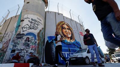 Palestinians walk in front of a mural depicting killed Palestinian-American journalist Shireen Abu Akleh in Bethlehem in the Israeli-occupied West Bank. Reuters