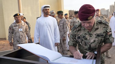King Abdullah II, King of Jordan (R), signs the guest book, after attending the UAE and Jordan joint military drill, entitled Bonds of Strength, at Al Hamra Camp.He is joined by Sheikh Mohamed bin Zayed, Crown Prince of Abu Dhabi and Deputy Supreme Commander of the UAE Armed Forces (2nd L).