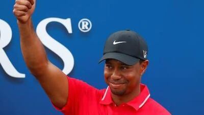 Tiger Woods reacts after being presented with The Players Championship trophy after winning the PGA golf tournament at TPC Sawgrass on Sunday. Chris Keane / Reuters