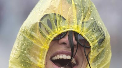 A reveller stands in the rain during the Pinkpop festival in Landgraaf, The Netherlands. Marcel van Hoorn / EPA