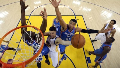 Klay Thompson #11 of the Golden State Warriors goes up for a shot against Serge Ibaka #9 and Andre Roberson #21 of the Oklahoma City Thunder in the first half of Game Seven of the Western Conference Finals during the 2016 NBA Playoffs at ORACLE Arena on May 30, 2016 in Oakland, California. Ezra Shaw/Getty Images/AFP