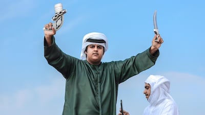 -Winners of the two year old camel contest hold up with awards during the winners' parade. Victor Besa / The National
