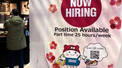 A hiring sign at a grocery store in Arlington Heights, Illinois. The pace of hiring in the US is showing surprising resilience in the face of higher interest rates across the economy, at least for now. AP