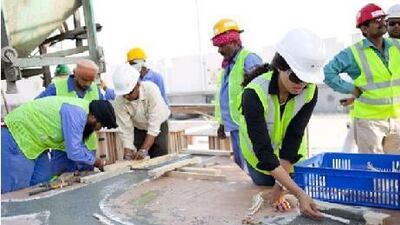 Tini Meyer, foreground, works on Samak last week in Musaffah. The German artist used fish bones in the sculpture. Rich-Joseph Facun / The National
