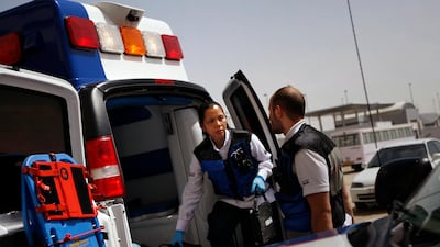 Emergency medical workers try to find the location of an injured man in the Muhaisnah labour camp in Dubai. Vehicles can face difficulty fighting their way through traffic to get to the injured. Amy Leang / The National