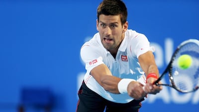 Novak Djokovic returns a volley during the Mubadala World Tennis Championship against Jo-Wilfried Tsonga at Zayed Sports City in Abu Dhabi on Friday. Djokovic won the match 7-6 6-3. Sammy Dallal / The National