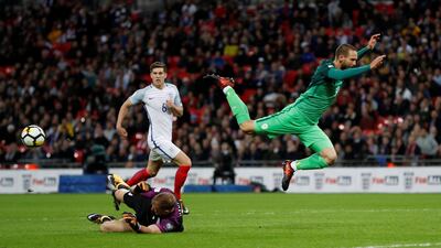 Slovenia’s Tim Matavz is sent tumbling after contact with Joe Hart. Darren Staples / Reuters