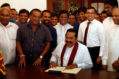 Former Sri Lankan President Mahinda Rajapaksa signs his letter of resignation as the contested prime minister at his official residence in Colombo. EPA