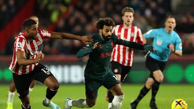 Liverpool's Mohamed Salah brushes off the challenge of Brentford defender Mathias Jorgensen. AFP