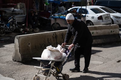 A Druze man moving goods in the market in Sweida. Photo: Hasan Belal for The National
