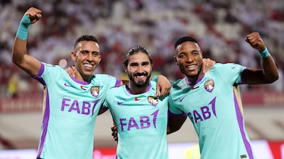 Al Ain's Erik, centre, celebrates after scoring in the 5-0 win against Sharjah that clinched the UAE Pro League title. All images: Chris Whiteoak / The National