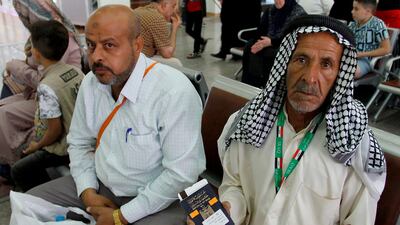 An Iraqi pilgrim shows his passport and ticket to Mecca as he waits for his flight at the airport in Najaf in southern-central Iraq on July 31, 2018, prior to the start of the annual Hajj pilgrimage in the holy city of Makkah. AFP