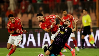 Al Ain's Yahia Nader tangles with Al Ahly's Wessam Ali. Reuters