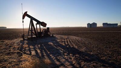 An idled pump jack sits rusting above a well on the edge of a farmers field near Ridgway, Illinois. Scott Olson / Getty Images / AFP