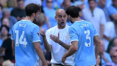 Pep Guardiola talks to Nico Gonzalez and Ruben Dias. EPA