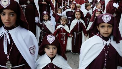 Penitents from the Ecce-Homo brotherhood take part in a procession in Ronda, Spain. Reuters